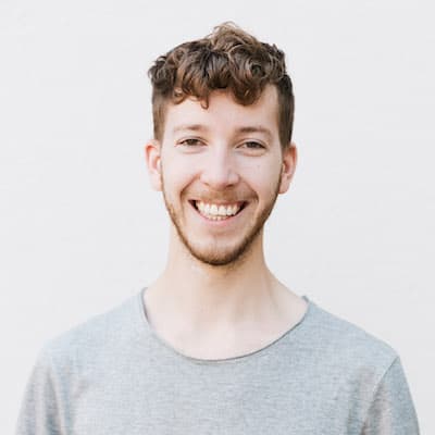 Fredrik smiling wearing a grey t-shirt